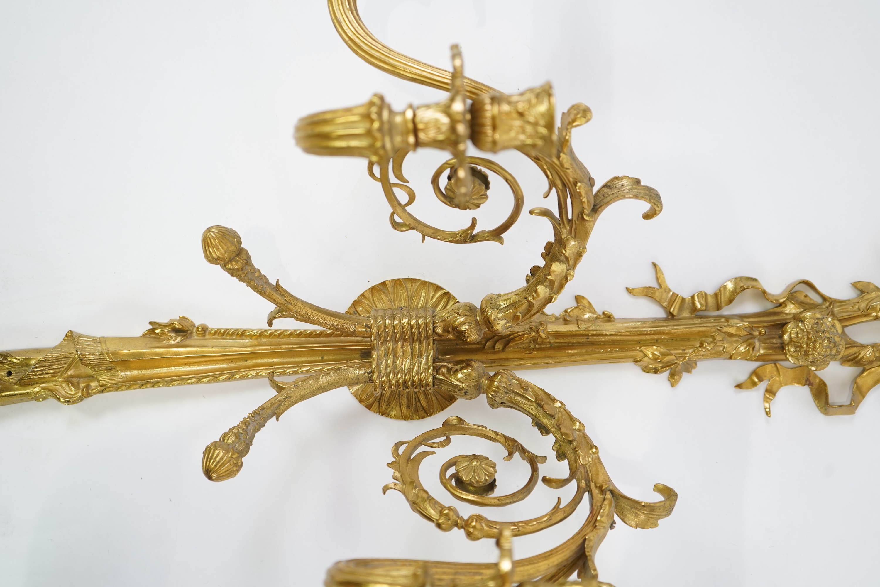 A pair of large Louis XVI style ormolu four branch wall sconces